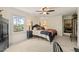 Bedroom with a four-poster bed, dark wood furniture, and a window with a view of a lush garden at 53 Lake Wendell Rd, Wendell, NC 27591