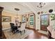 Stylish dining room featuring hardwood floors, decorative lighting, and large windows at 53 Lake Wendell Rd, Wendell, NC 27591