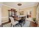 Charming dining room with hardwood floors, chandelier, and a view into the kitchen at 53 Lake Wendell Rd, Wendell, NC 27591