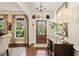 Elegant foyer with hardwood floors, decorative mirror, and a view of the beautifully landscaped front yard at 53 Lake Wendell Rd, Wendell, NC 27591