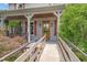 Inviting front porch features wooden accents, string lights, and a warm welcome sign at 53 Lake Wendell Rd, Wendell, NC 27591