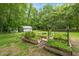 Lush garden with raised garden beds, surrounded by greenery and mature trees for a serene setting at 53 Lake Wendell Rd, Wendell, NC 27591