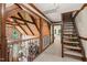 Hallway view with an open wood truss and an open staircase leading to the main bedroom at 53 Lake Wendell Rd, Wendell, NC 27591