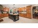 This kitchen has custom cabinetry, a granite island, stainless steel appliances, and a tile floor at 53 Lake Wendell Rd, Wendell, NC 27591