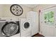 Functional laundry room with modern washer and dryer, plus extra storage space at 53 Lake Wendell Rd, Wendell, NC 27591