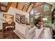 Inviting living room with a stone fireplace, vaulted wood ceilings, and hardwood floors at 53 Lake Wendell Rd, Wendell, NC 27591