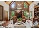 Living room boasts a stone fireplace, wood floors, and large windows offering picturesque views at 53 Lake Wendell Rd, Wendell, NC 27591