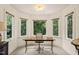 Bright office space with a desk, chair and large windows offering views of the lush greenery at 53 Lake Wendell Rd, Wendell, NC 27591