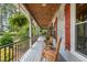 Inviting covered porch with rocking chairs and views of the lush surrounding landscape at 53 Lake Wendell Rd, Wendell, NC 27591