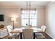 Bright dining room with elegant lighting fixture and neutral decor at 6147 Beale Loop, Raleigh, NC 27616
