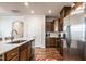Modern kitchen with stainless steel appliances, an island, and dark cabinetry at 6147 Beale Loop, Raleigh, NC 27616