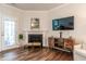 Inviting living room featuring a fireplace, hardwood floors, and a rear entrance at 6147 Beale Loop, Raleigh, NC 27616