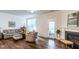 Bright living room featuring a fireplace, hardwood floors, and a comfortable seating arrangement at 6147 Beale Loop, Raleigh, NC 27616