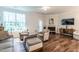 Cozy living room with fireplace, hardwood floors, and neutral colored walls at 6147 Beale Loop, Raleigh, NC 27616