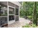Covered screened patio with outdoor seating, adjacent to a stone tile patio at 6147 Beale Loop, Raleigh, NC 27616