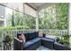 Relaxing screened porch with a cushioned wicker sectional and view of the wooded backyard at 6147 Beale Loop, Raleigh, NC 27616