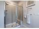 Modern shower with glass door, tiled walls, and a built-in seat and shelving at 6147 Beale Loop, Raleigh, NC 27616