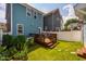 Manicured backyard with a small deck, lush green grass, and garden beds perfect for outdoor enjoyment at 644 Granite Mill Blvd, Chapel Hill, NC 27516