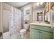 Well-lit bathroom featuring a shower-tub combo, toilet, and sage vanity with white countertop at 644 Granite Mill Blvd, Chapel Hill, NC 27516