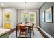 Open dining room with modern light fixture, wood table, and a gray accent wall at 644 Granite Mill Blvd, Chapel Hill, NC 27516