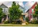 Charming blue two-story home with a yellow door and a well-maintained front yard with beautiful landscaping at 644 Granite Mill Blvd, Chapel Hill, NC 27516