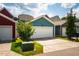 Attached two car garage with white door and driveway, surrounded by greenery and well-kept lawns at 644 Granite Mill Blvd, Chapel Hill, NC 27516
