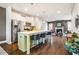 Open kitchen with island, bar seating, stainless steel appliances, and hardwood floors at 644 Granite Mill Blvd, Chapel Hill, NC 27516