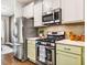 Kitchen features stainless steel appliances, white countertops, and light green cabinets at 644 Granite Mill Blvd, Chapel Hill, NC 27516