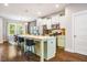 Open concept kitchen with an island, bar stools, stainless appliances, and hardwood flooring at 644 Granite Mill Blvd, Chapel Hill, NC 27516