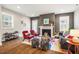 Bright living room featuring a fireplace, hardwood floors, and comfortable seating at 644 Granite Mill Blvd, Chapel Hill, NC 27516