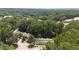 An aerial view of the townhomes, showing a parking lot and wooded scenery at 7159 Sandy Creek Dr, Raleigh, NC 27615
