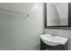 Stylish half-bathroom featuring a modern vanity, enhancing the functionality and appeal of the space at 7159 Sandy Creek Dr, Raleigh, NC 27615