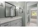 Renovated bathroom featuring a modern single sink vanity and a large mirror at 7159 Sandy Creek Dr, Raleigh, NC 27615