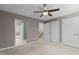 Bright bedroom with white trim, doors, and closet spaces with carpet flooring at 7159 Sandy Creek Dr, Raleigh, NC 27615