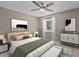 Cozy bedroom featuring neutral walls, a ceiling fan, and stylish decor at 7159 Sandy Creek Dr, Raleigh, NC 27615