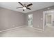 Primary bedroom with a ceiling fan, neutral walls, and an attached bathroom with a double sink vanity at 7159 Sandy Creek Dr, Raleigh, NC 27615