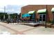 Exterior patio with tables, chairs, umbrellas, and handicap access at 7159 Sandy Creek Dr, Raleigh, NC 27615