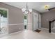 Bright dining area with large window, tile floors, and classic lighting fixture for memorable meals at 7159 Sandy Creek Dr, Raleigh, NC 27615