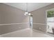 Cozy dining area with tiled floor, natural light, and modern chandelier at 7159 Sandy Creek Dr, Raleigh, NC 27615