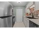 Modern kitchen with stainless steel appliances, granite countertops, and tiled backsplash, blending style with functionality at 7159 Sandy Creek Dr, Raleigh, NC 27615
