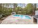 Community in-ground pool with large concrete deck, shed and bench seating at 7159 Sandy Creek Dr, Raleigh, NC 27615