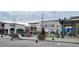 Outdoor shopping center with a variety of stores, seating, and a landscaped plaza for community gatherings at 7159 Sandy Creek Dr, Raleigh, NC 27615