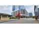 View of Rosewater Kitchen & Bar, with modern highrise buildings and parking deck in the background at 7159 Sandy Creek Dr, Raleigh, NC 27615