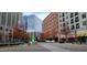 City street view featuring a mix of modern office buildings, retail spaces, and tree-lined sidewalks at 7159 Sandy Creek Dr, Raleigh, NC 27615