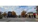 Neighborhood street view featuring restaurants and retail locations, tree-lined streets, and decorative planters at 7159 Sandy Creek Dr, Raleigh, NC 27615