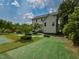 Manicured backyard featuring lush greenery, mature trees, and a well-maintained lawn, perfect for outdoor enjoyment at 723 Lindley Dr, Durham, NC 27703