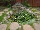 Backyard pond with a rock waterfall and lily pads creating a serene, natural feature at 723 Lindley Dr, Durham, NC 27703