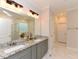 Bright bathroom features double vanity with granite countertop and a decorative mirror at 723 Lindley Dr, Durham, NC 27703