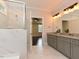 Modern bathroom with double sinks, granite counters, and a glass-enclosed shower connected to bedroom at 723 Lindley Dr, Durham, NC 27703