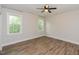 Bright bedroom featuring hardwood floors, two windows offering natural light, creating a comfortable and inviting retreat at 723 Lindley Dr, Durham, NC 27703